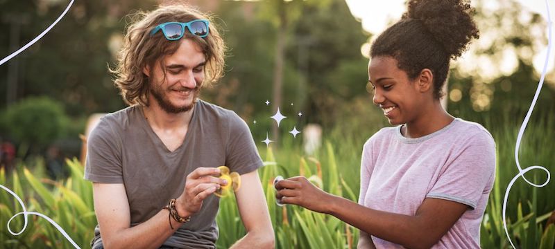 Two people playing with fidget spinners